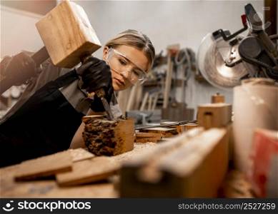 female carpenter studio with wood sculpting tools