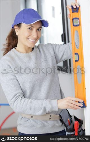 female carpenter using a level