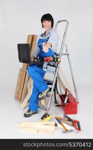 Female carpenter with a laptop