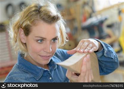 female carpenter with a piece of wood shape