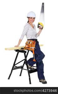 Female carpenter with a saw