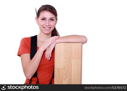 Female carpenter with laminate flooring