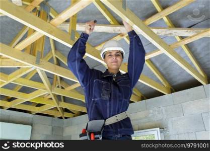 female carpenter working on a wood structure