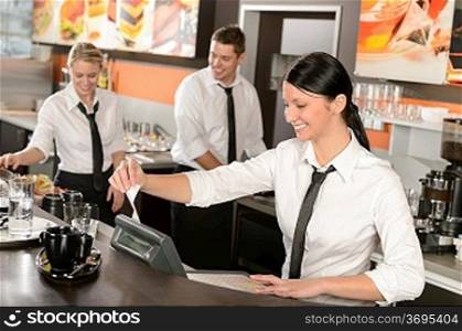 Female cashier giving receipt colleagues working in cafe