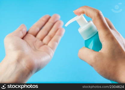 Female caucasian person applying dry wash antibacterial sanitizer gel on hands, increased personal hygiene after global Coronavirus COVID-19 virus disease, prevention and protection from spreading