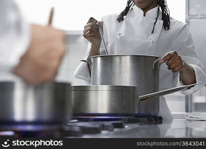 Female chef cooking in kitchen