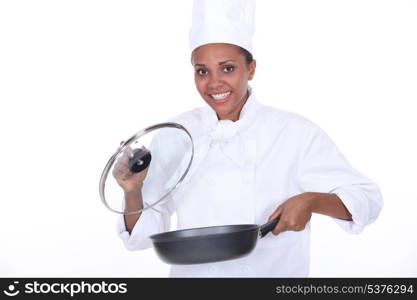 female chef exhibits a frying pan