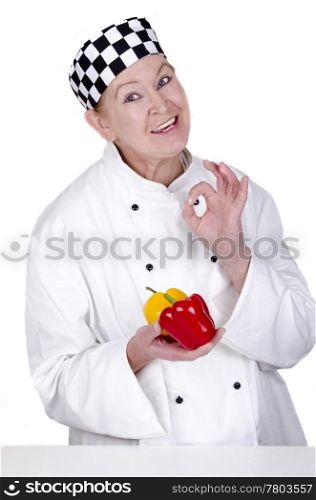 female chef holding red and yellow peppers in her hand. some organic acacia honey in a small glass