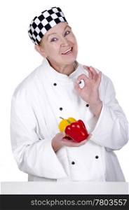 female chef holding red and yellow peppers in her hand. some organic acacia honey in a small glass