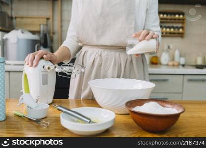 female chef preparing pie kitchen with ingredients table