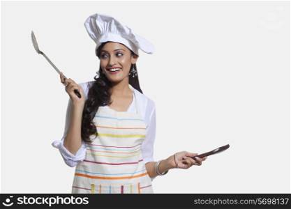 Female chef with cooking utensils