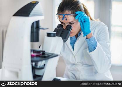 Female chemist or lab technician researching s&les in laboratory