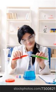Female chemist working at the lab  