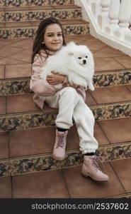 female child hugging her fluffy companion