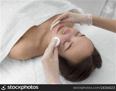 female client salon face care routine with cleansing disks 6