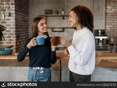 female colleagues having coffee during meeting
