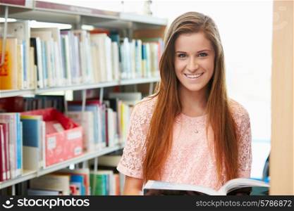 Female College Student Studying In Library