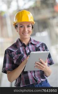 female construction engineer working on laptop at site