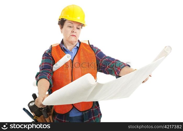 Female construction worker going over the blueprints for the job. Isolated.
