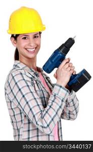 Female construction worker holding a drill