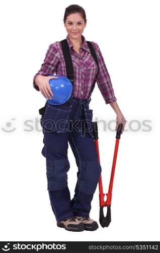 Female construction worker holding a large tool