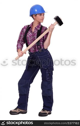 Female construction worker holding a rubber mallet