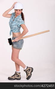 Female construction worker holding a sledgehammer.