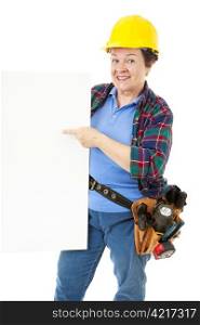 Female construction worker holding and pointing to a blank sign, ready for your text.