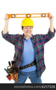Female construction worker jokes around with a level on her head. Isolated on white.