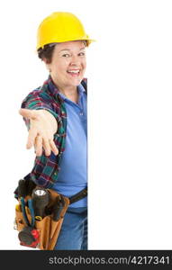 Female construction worker leaning around blank white space, making a presenting gesture. Isolated design element.