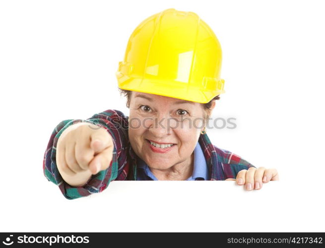 Female construction worker pointing at you over blank white space. Isolated design element.