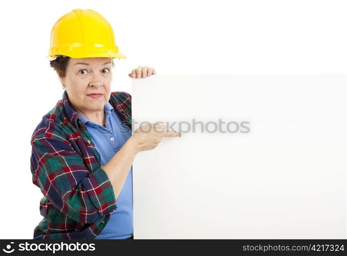 Female construction worker points at blank white space, ready for text. Isolated on white.
