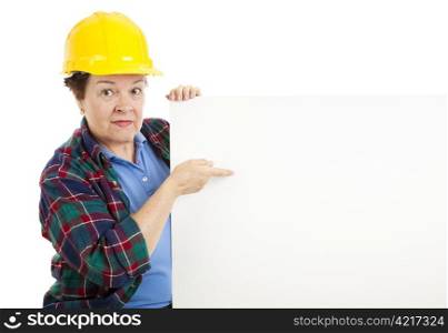 Female construction worker points at blank white space, ready for text. Isolated on white.