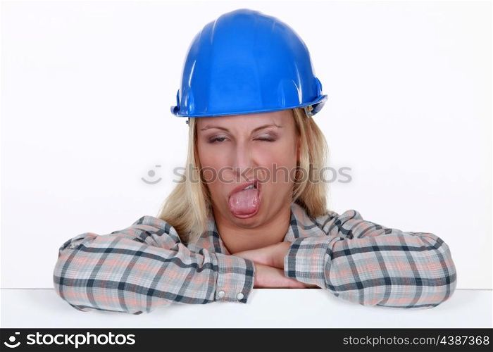 Female construction worker pulling a silly face