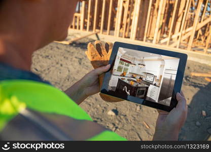 Female Construction Worker Reviewing Kitchen on Computer Pad at Construction Site.