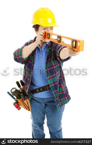Female construction worker using a level. Isolated on white.