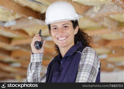 female construction worker using walkie talkie