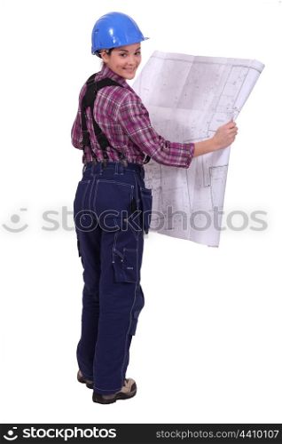 female construction worker watching a blueprint