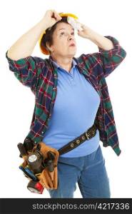 Female construction worker wipes sweat from her forehead. Isolated on white.