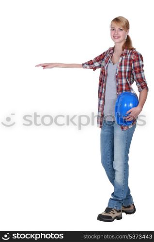 Female construction worker with a blank board