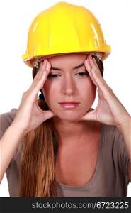 Female construction worker with a headache