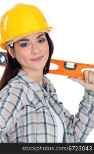 Female construction worker with a level.