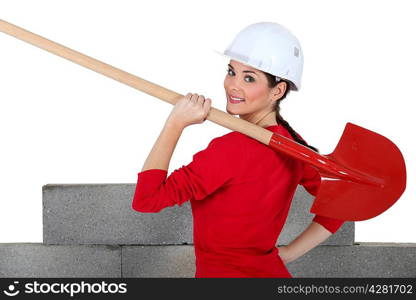 Female construction worker with a shovel