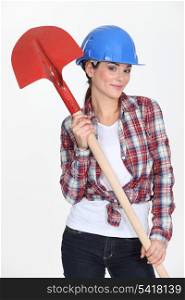Female construction worker with a shovel