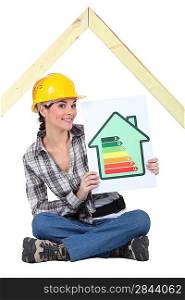 Female construction worker with an energy rating sign