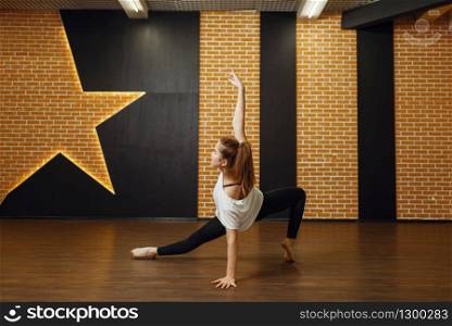 Female contemporary dance performer, body flexibility. Dancer on workout in class, modern ballet, elegance dancing, stretching exercise. Contemporary dance performer, body flexibility