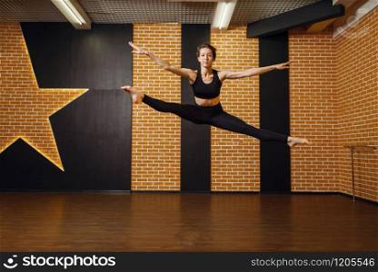 Female contemporary dance performer, jump in motion, training in studio. Dancer on workout in class, modern ballet, elegance dancing, stretching exercise. Contemporary dance performer, jump in motion
