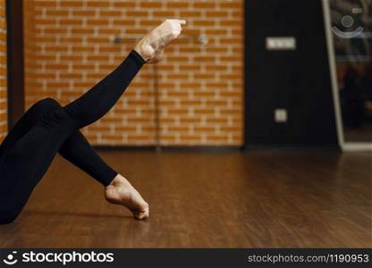 Female contemporary dance performer legs flexibility, stretching exercise, women on workout in studio. Dancers training in class, modern ballet, elegance dancing. Female contemporary dance performer legs
