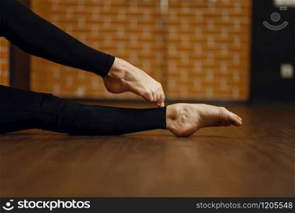 Female contemporary dance performer legs flexibility, stretching exercise, women on workout in studio. Dancers training in class, modern ballet, elegance dancing