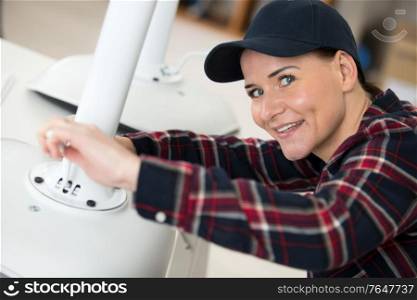 female contractor repairing a chair